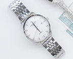 Stainless steel Longines wristwatch with white dial and metal link bracelet.