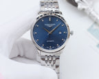 Stainless steel Longines wristwatch with blue dial, silver hands, and metal bracelet.