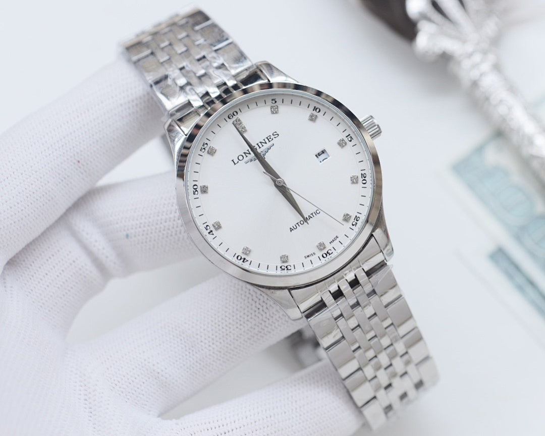 Stainless steel Longines wristwatch with white dial and metal link bracelet close-up.