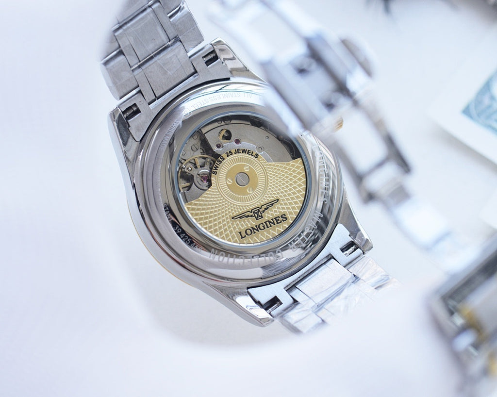 Longines wristwatch caseback view, exposed movement, silver link bracelet.