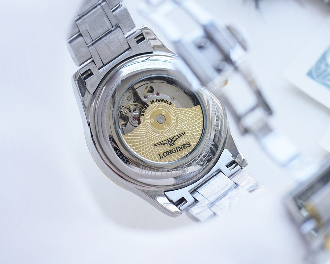 Longines wristwatch caseback view, exposed movement, silver link bracelet.