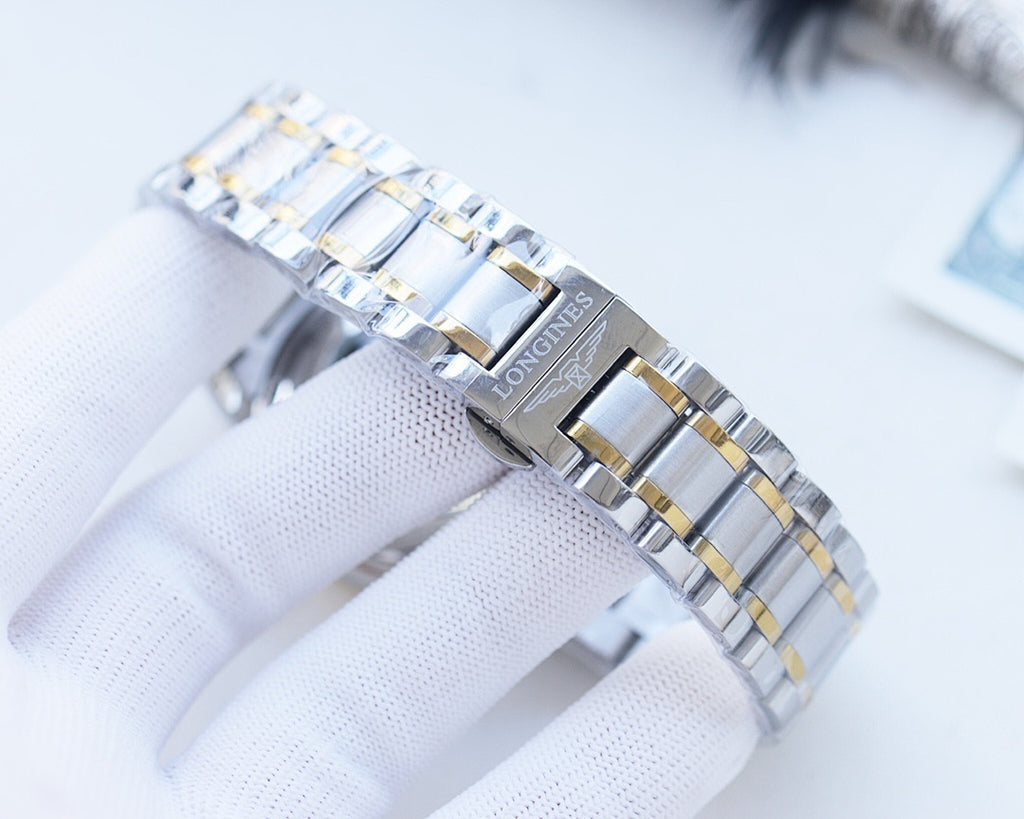 Longines wristwatch bracelet detail, silver links with gold-tone center bars.