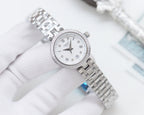 Silver Longines watch with white dial, roman numerals, and metal bracelet