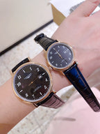 Pair of Longines watches with dark and white dials, dark leather straps, rose-gold cases.
