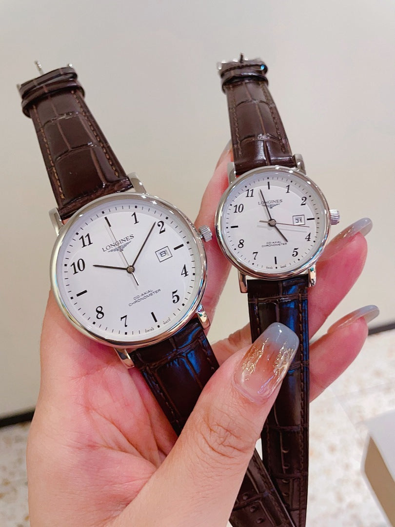 Pair of Longines watches with white and white dials, brown and blue leather straps, gold cases.