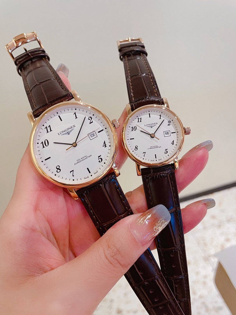 Pair of Longines watches with white dials, brown leather straps, rose-gold cases.