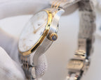 Longines wristwatch side profile with crown and two-tone metal bracelet