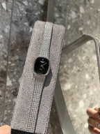 Square wristwatch with black dial and silver mesh strap, close-up
