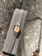Square wristwatch with light dial and silver mesh strap, close-up