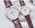 Quartz wristwatches with brown leather straps and white dials, silver cases