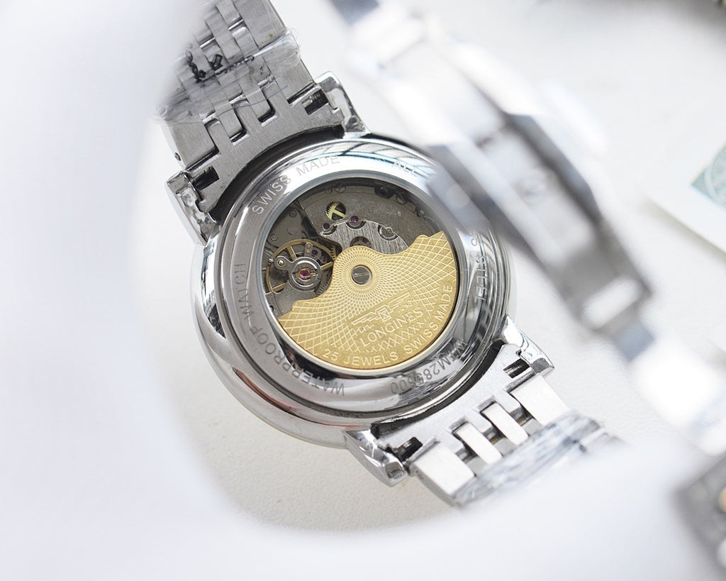 Longines wristwatch case open view with gold-toned dial details and metal bracelet.