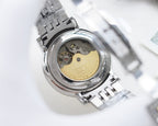 Longines wristwatch case open view with gold-toned dial details and metal bracelet.