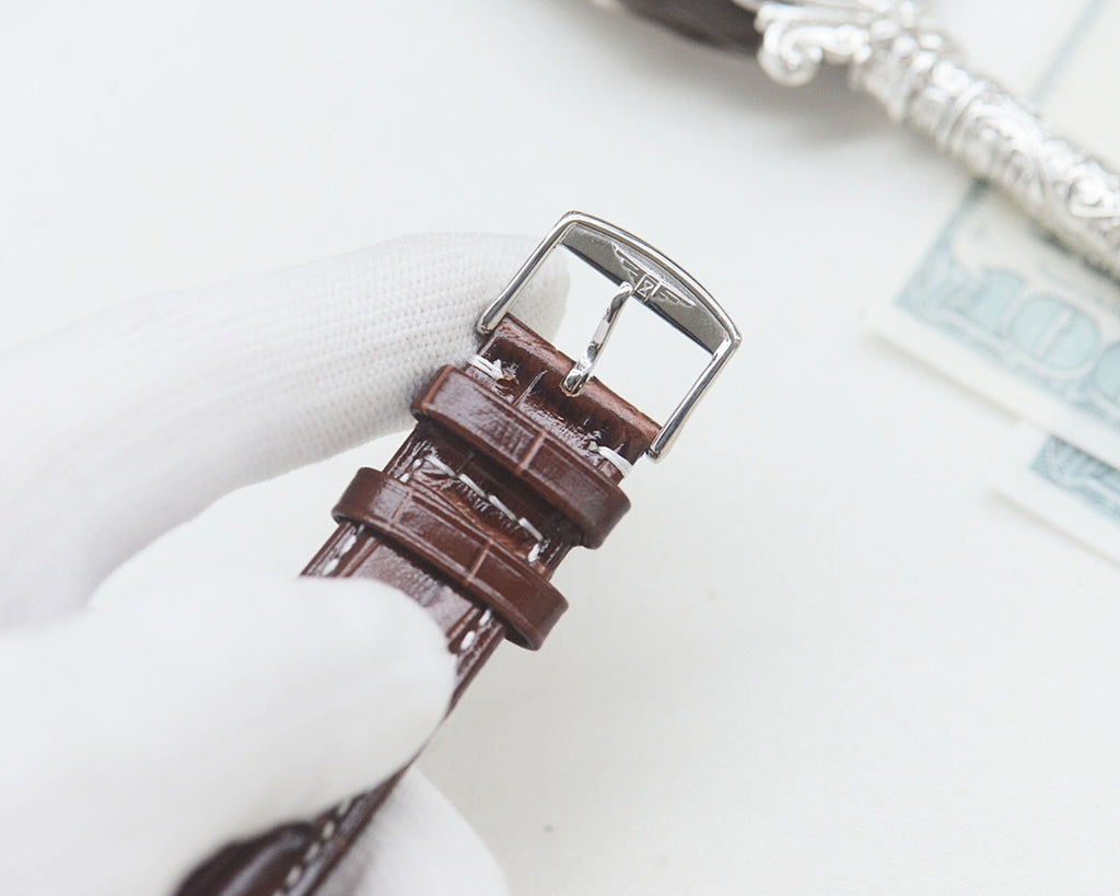 Longines wrist watch with brown leather strap and silver-tone buckle.