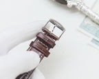 Longines wrist watch with brown leather strap and silver-tone buckle.