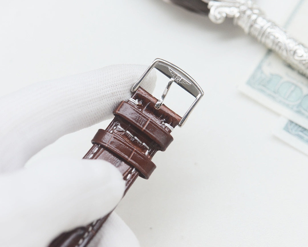 Longines wrist watch with brown leather strap and silver-tone buckle.