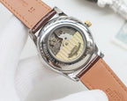 Longines wrist watch with see-through caseback movement, tan-brown leather strap.