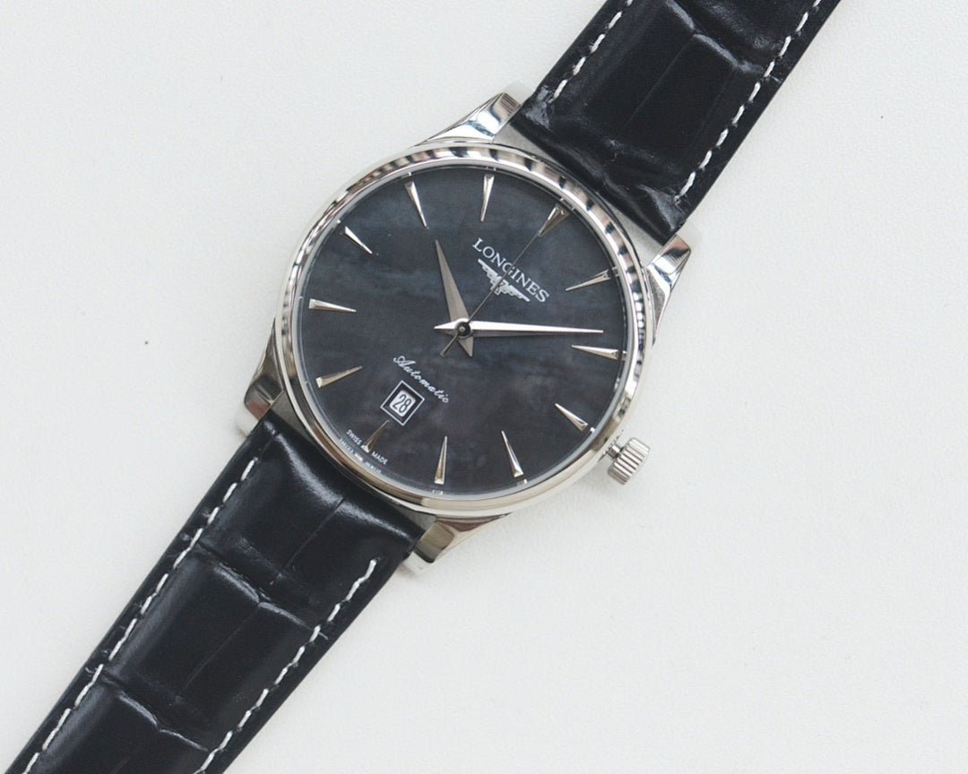 Longines wrist watch with silver-tone case, dark dial, black leather strap.