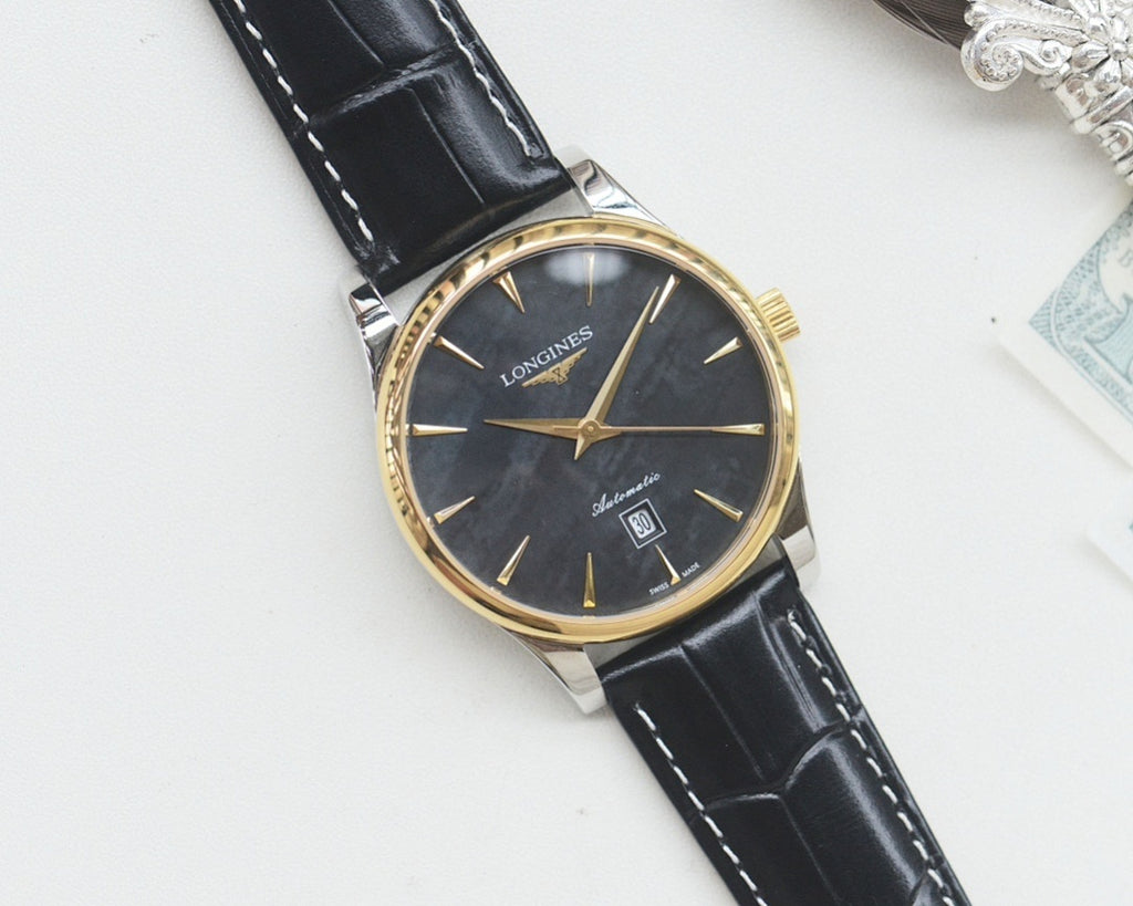 Longines wrist watch with gold-tone case, dark dial, black leather strap.