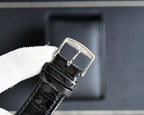 Automatic wristwatch buckle and strap clasp, black leather with stitched edges and metal frame
