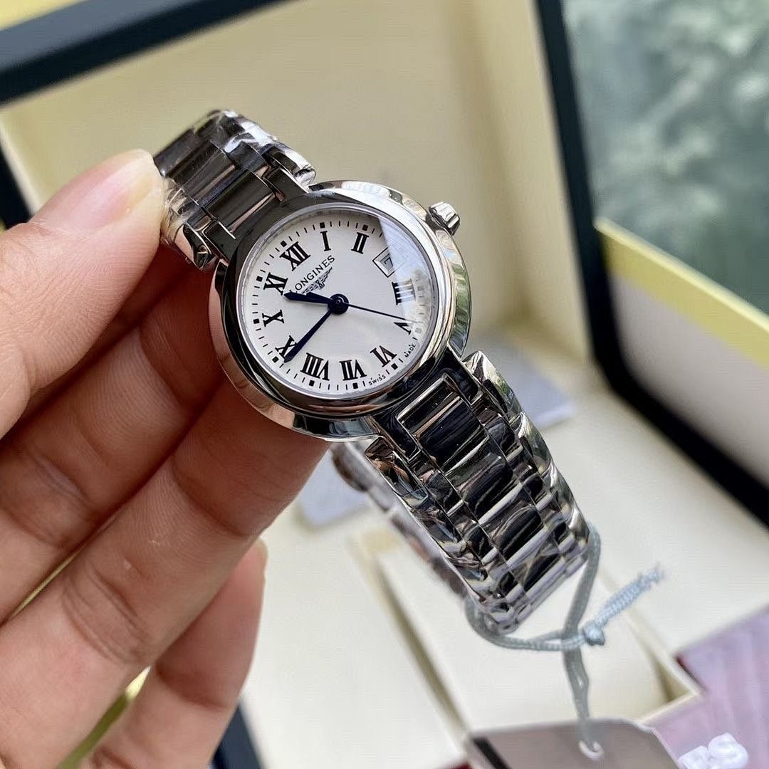 Longines watch with silver round case, white dial, and stainless steel link bracelet