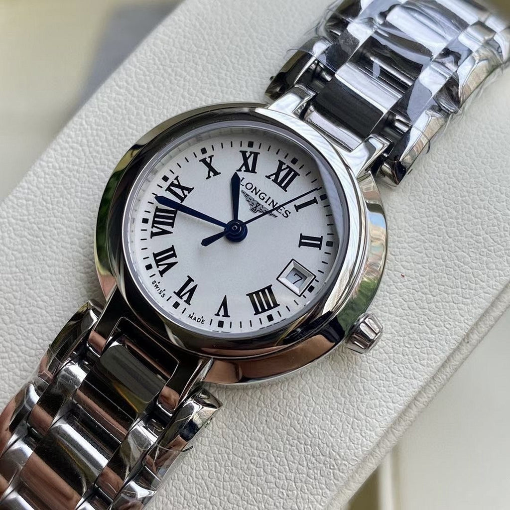 Longines watch close-up with white dial, Roman numerals, and stainless steel bracelet