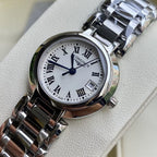 Longines watch close-up with white dial, Roman numerals, and stainless steel bracelet