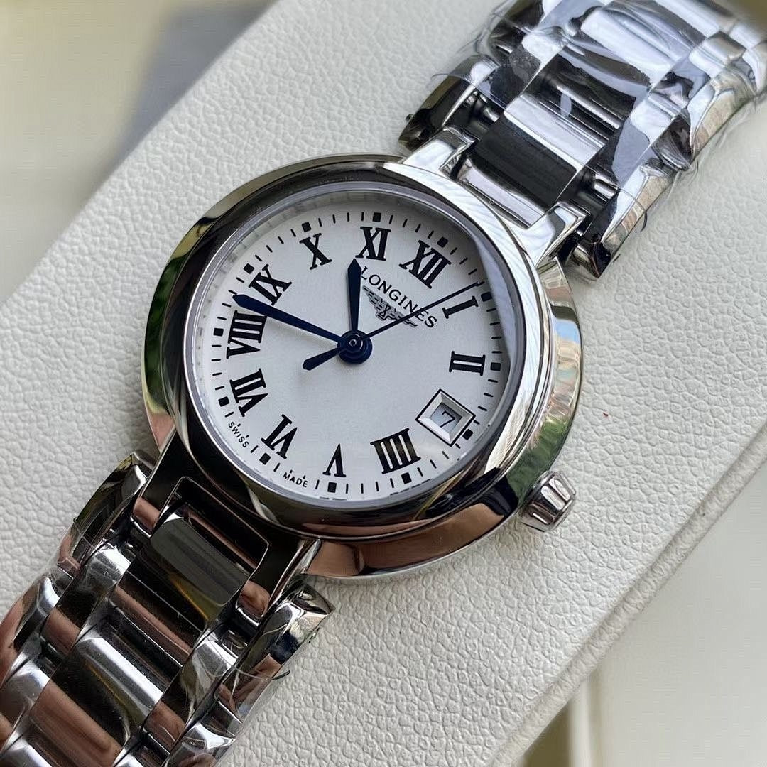 Longines watch close-up with white dial, Roman numerals, and stainless steel bracelet
