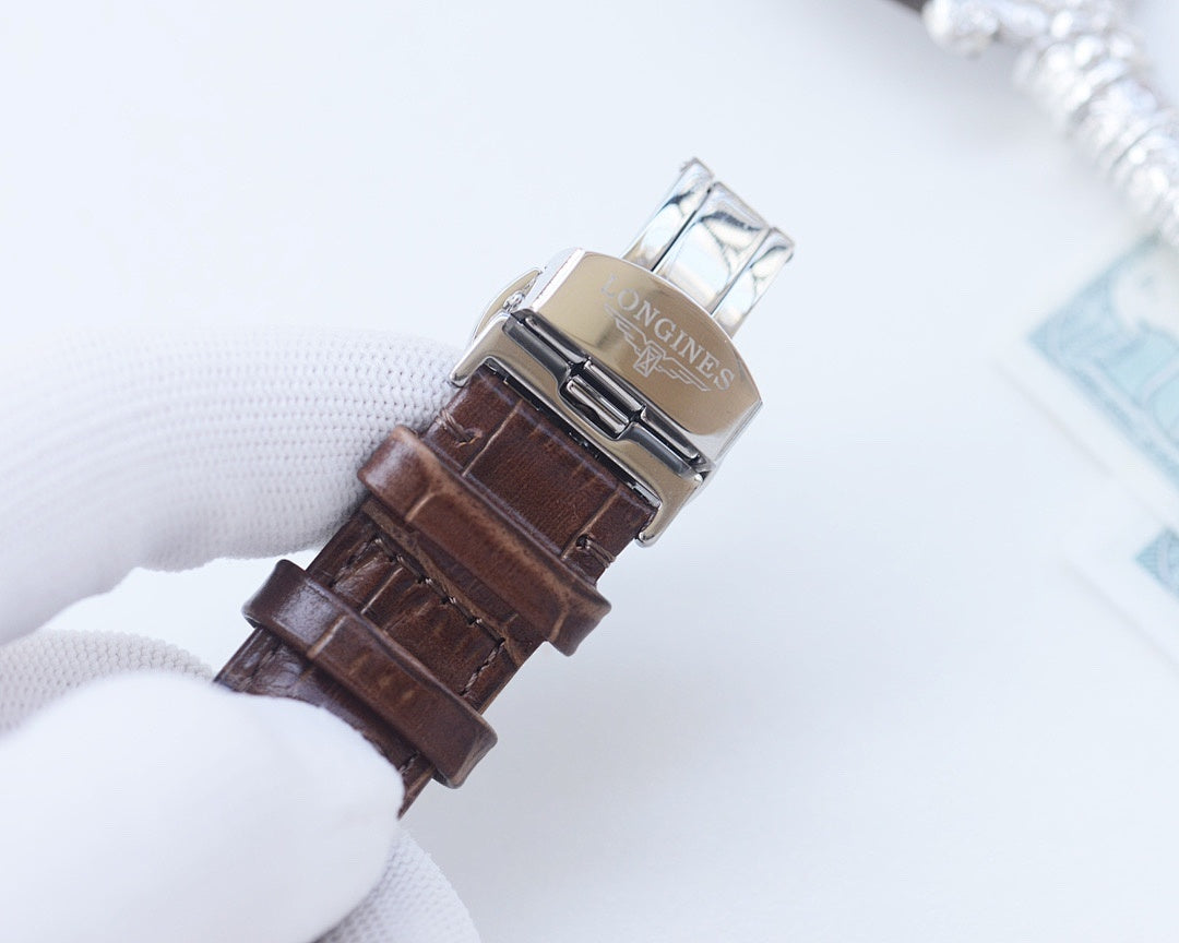 Analog wristwatch with brown leather strap and silver-tone metal buckle