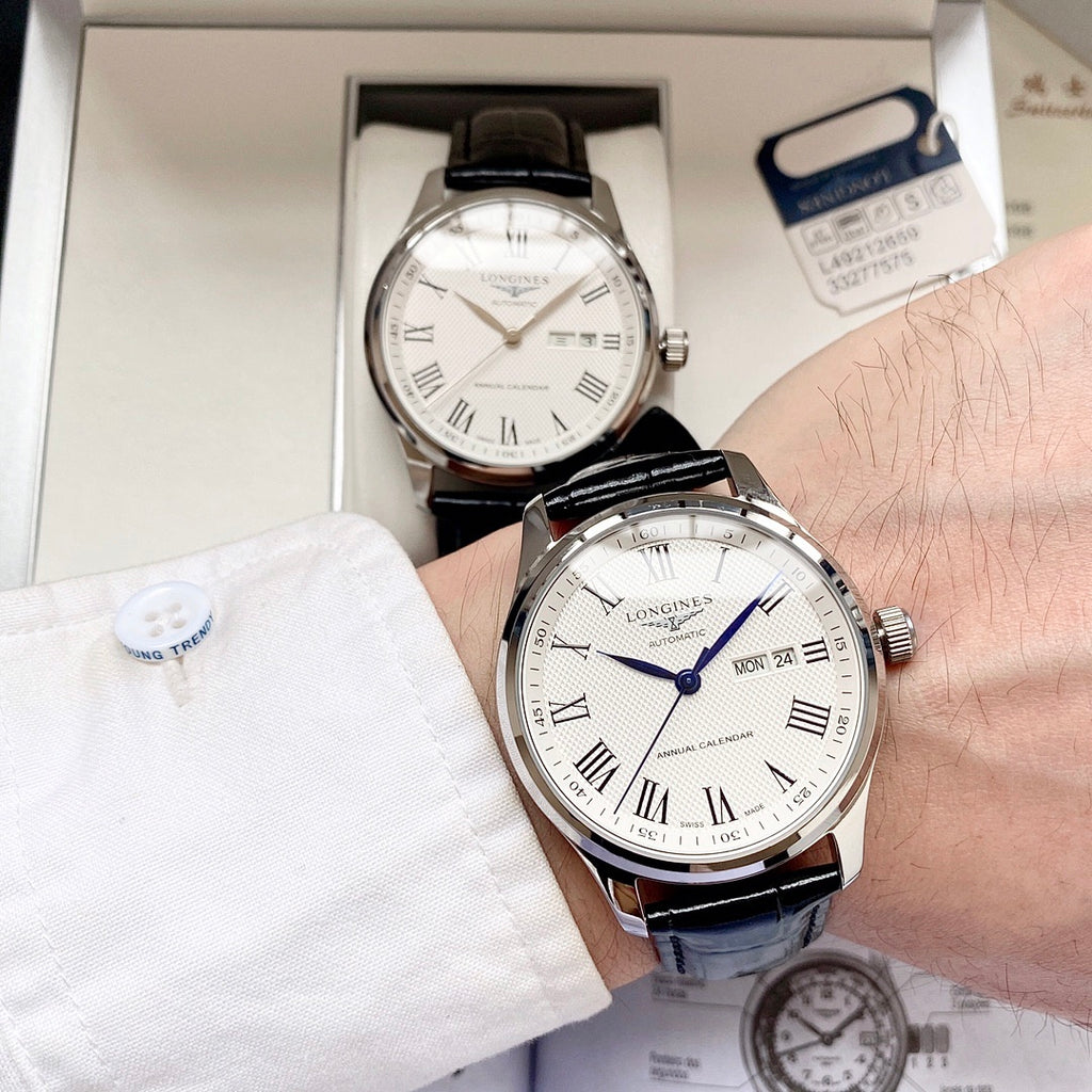 Automatic watch with white dial, black leather strap, Roman numerals and date window