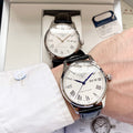 Automatic watch with white dial, black leather strap, Roman numerals and date window