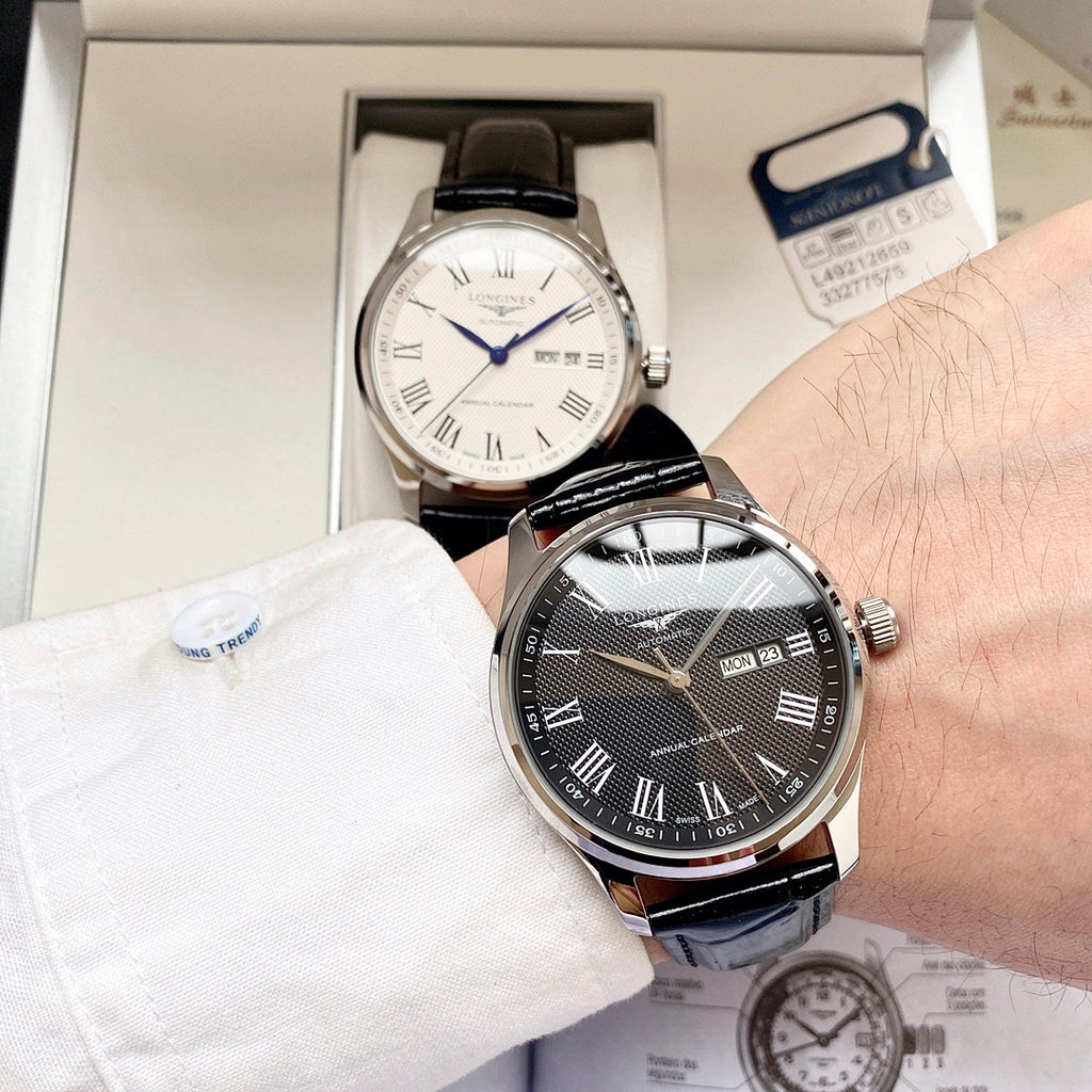 Automatic watch with dark dial, gold-toned case and black leather strap, day/date visible