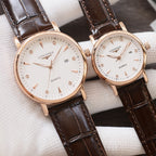 Longines quartz wristwatches with white dials and brown leather straps, rose-gold cases, two-pack
