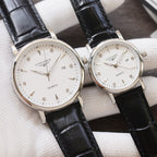 Longines quartz wristwatches with white dials and black leather straps, silver-tone cases, two-pack