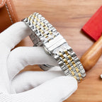 Longines watch bracelet close-up with silver links and gold accents on the clasp