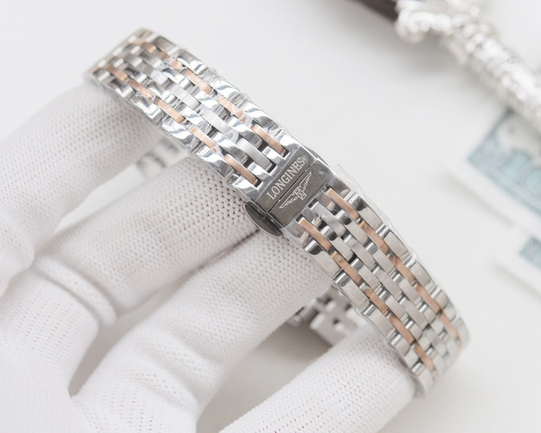 Longines watch on silver steel bracelet, side view with clasp and textured case detail