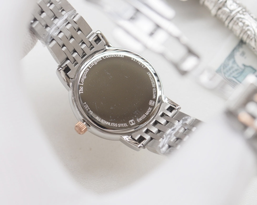 Longines watch case back on silver steel bracelet with engraved text and stainless steel marking