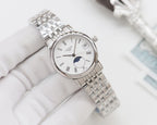 Longines watch with silver steel bracelet, white dial, moonphase display and minimalist index markers