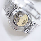 Longines automatic watch with open movement view and silver-tone bracelet