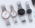 Two Tissot watches with stainless steel bracelets, one white dial and one dark dial