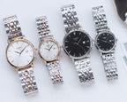 Two Tissot watches with stainless steel bracelets, one white dial and one dark dial