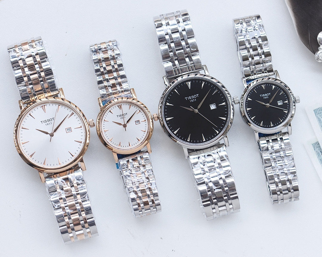 Two Tissot watches with stainless steel bracelets, one white dial and one dark dial