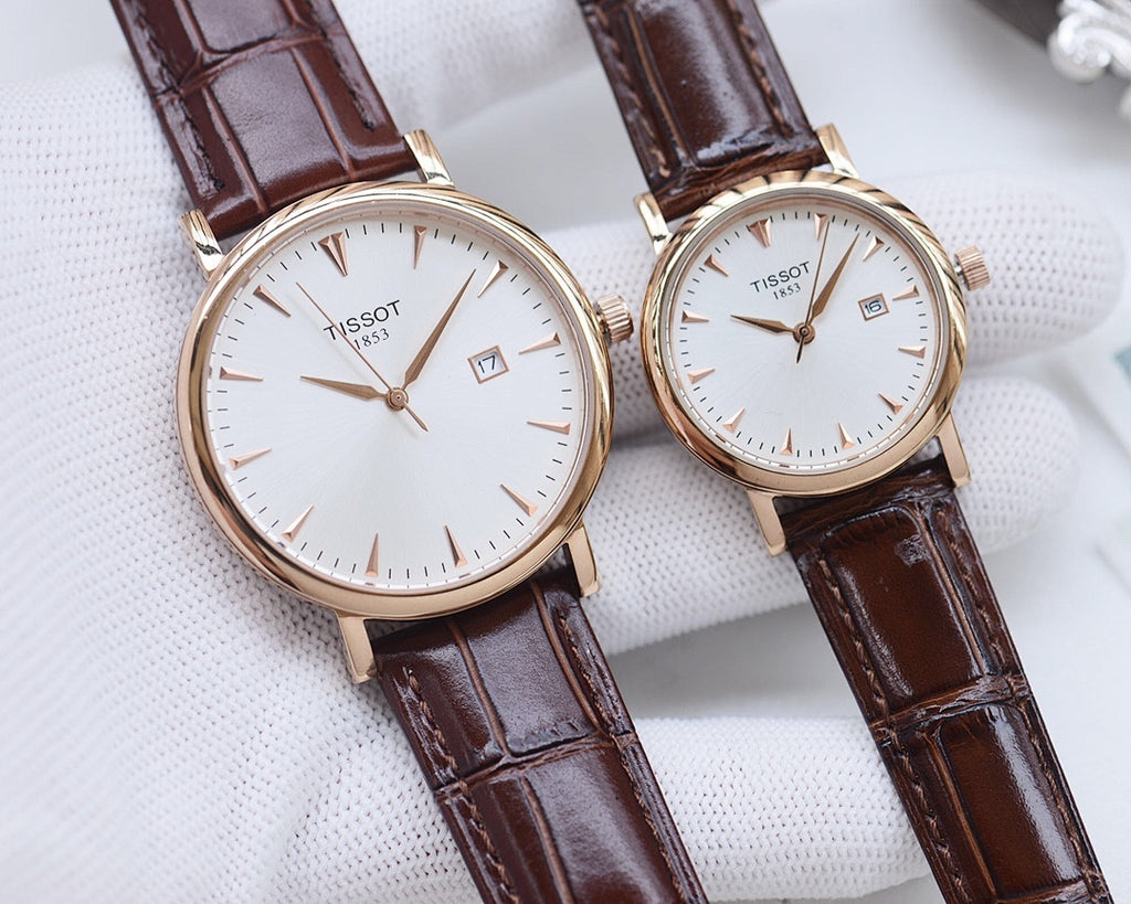Two Tissot watches with brown leather straps and white round dials