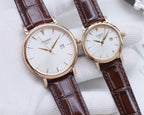 Two Tissot watches with brown leather straps and white round dials