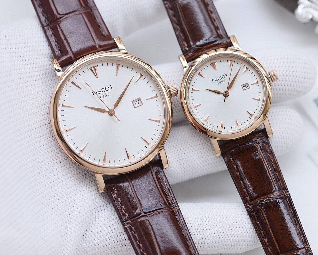 Two Tissot watches with brown leather straps and white round dials