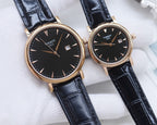 Two Tissot watches with gold-tone cases and black dials on dark leather straps