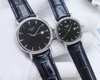 Two Tissot watches with black dials and dark blue leather straps