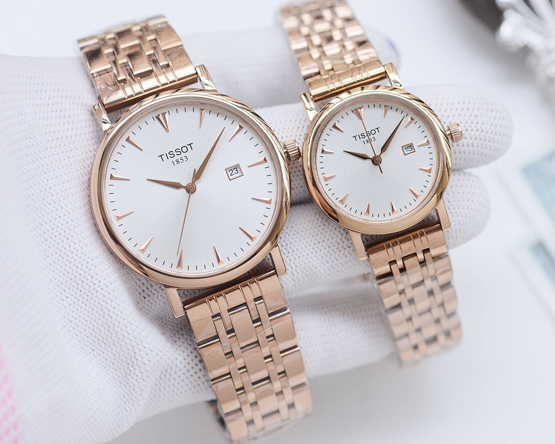 Two Tissot watches with gold-tone metal bracelets and white round dials