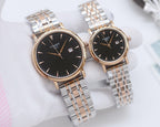 Two Tissot watches with dark dials and gold-tone cases on metal bracelets