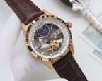 Gold-tone skeleton analog watch with blue subdial, brown leather strap, ornate dial