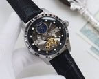 Silver-tone analog watch with black dial, blue subdial, skeleton movement, black leather strap